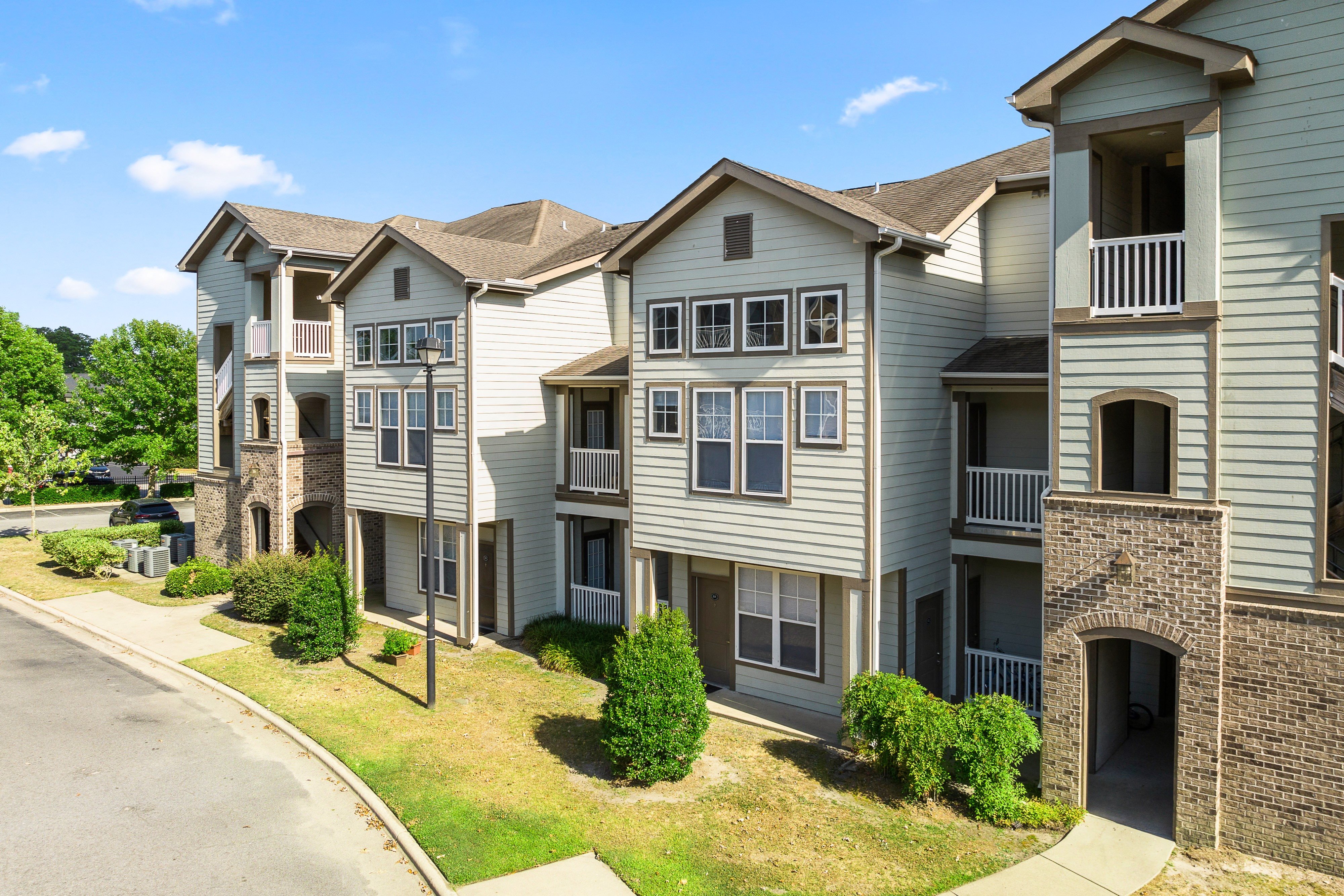 an exterior view of an apartment building on a street